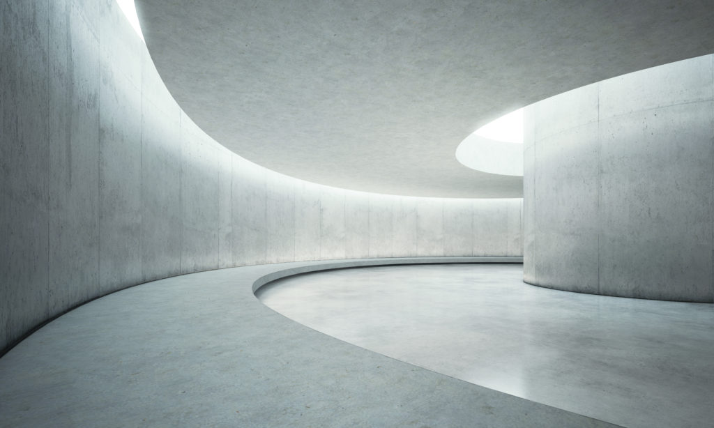 curving concrete corridor with accent lights