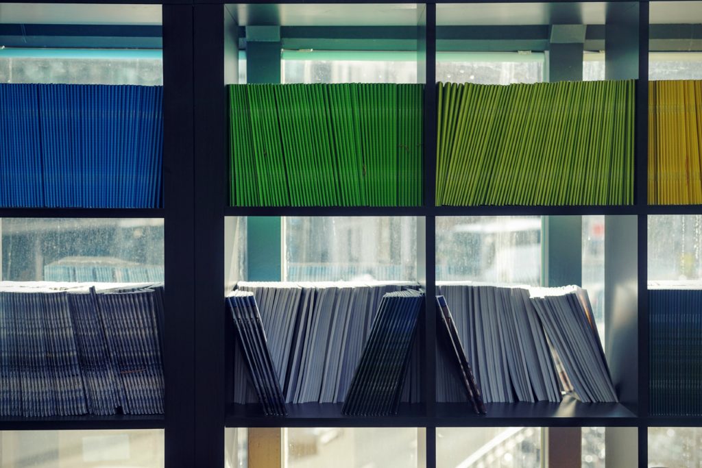 Multicolored Folders Organized on a Shelf | OpenAsset