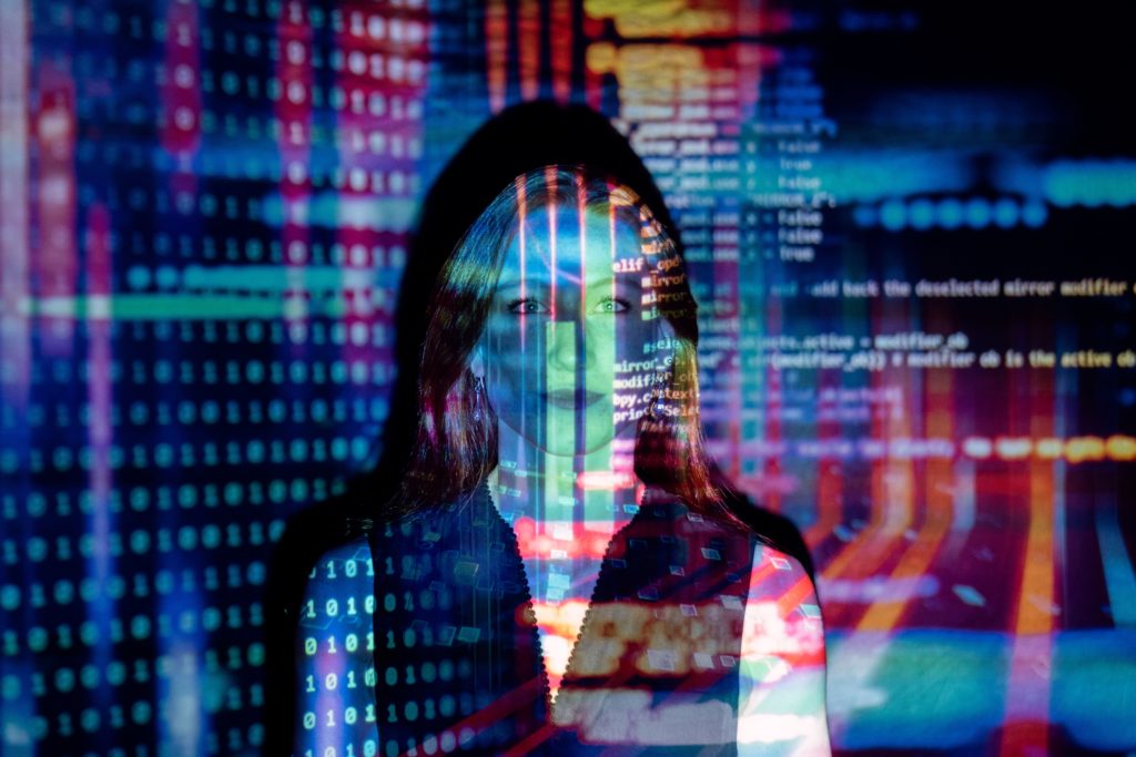 Woman overlaid with projection of code | OpenAsset