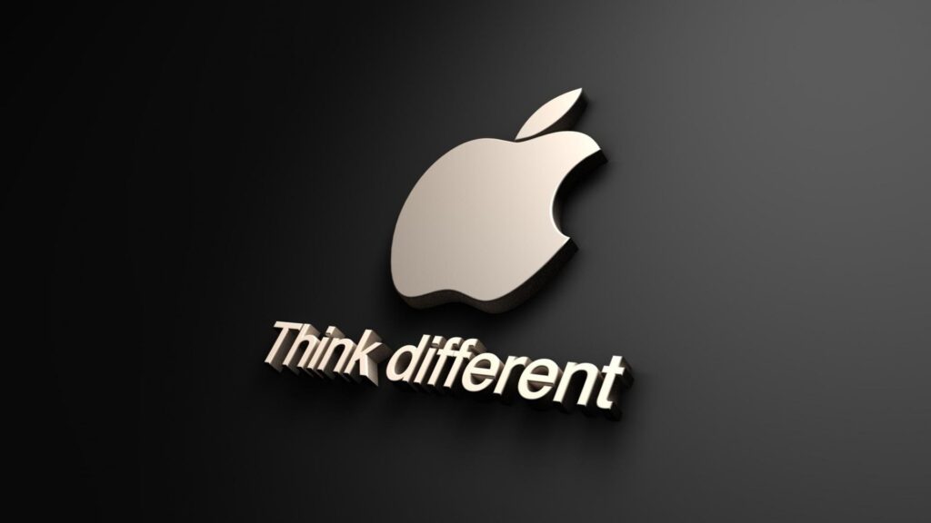 A close-up of the Apple logo with the words "think different" written under it 

