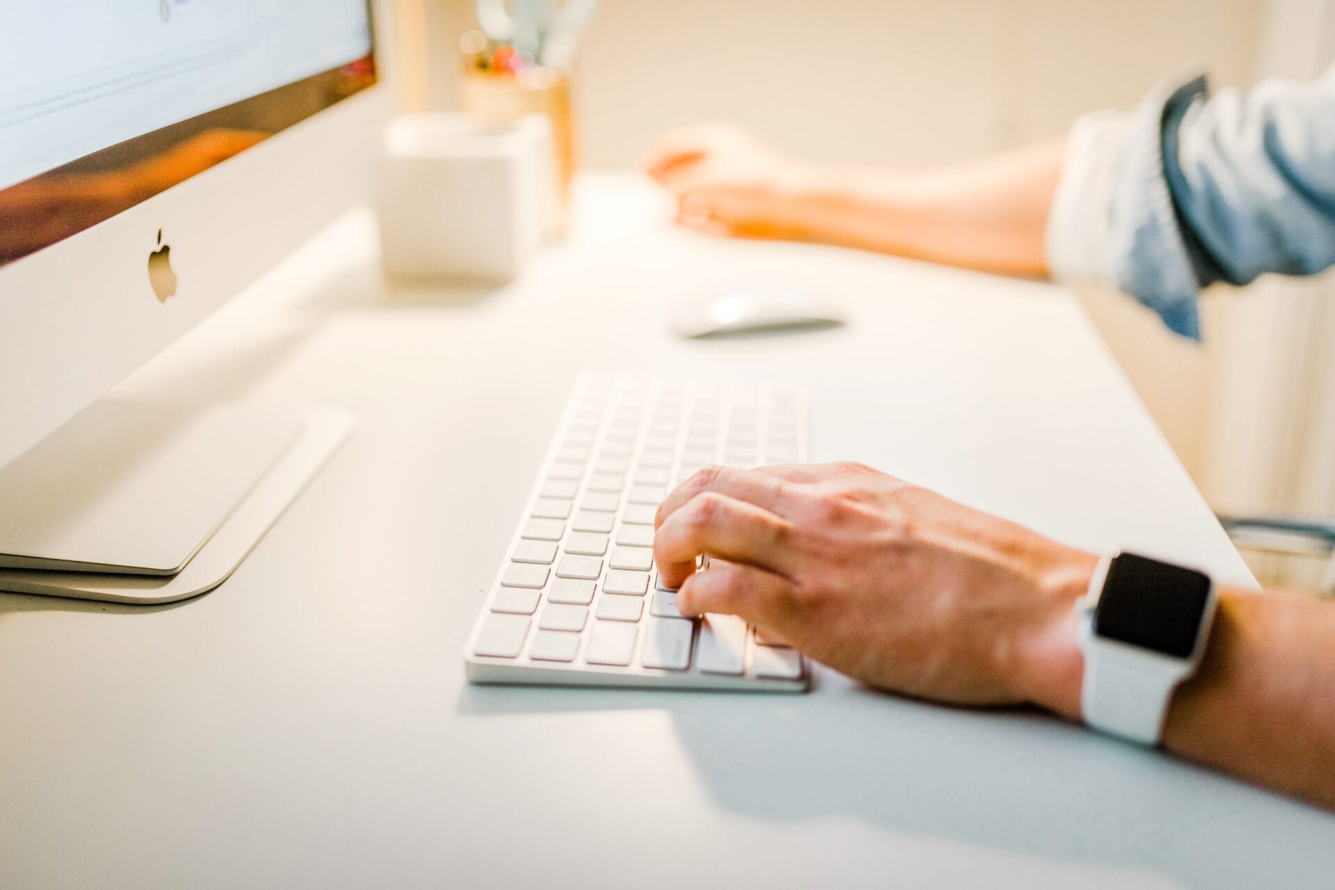 Man typing on Apple keyboard | OpenAsset