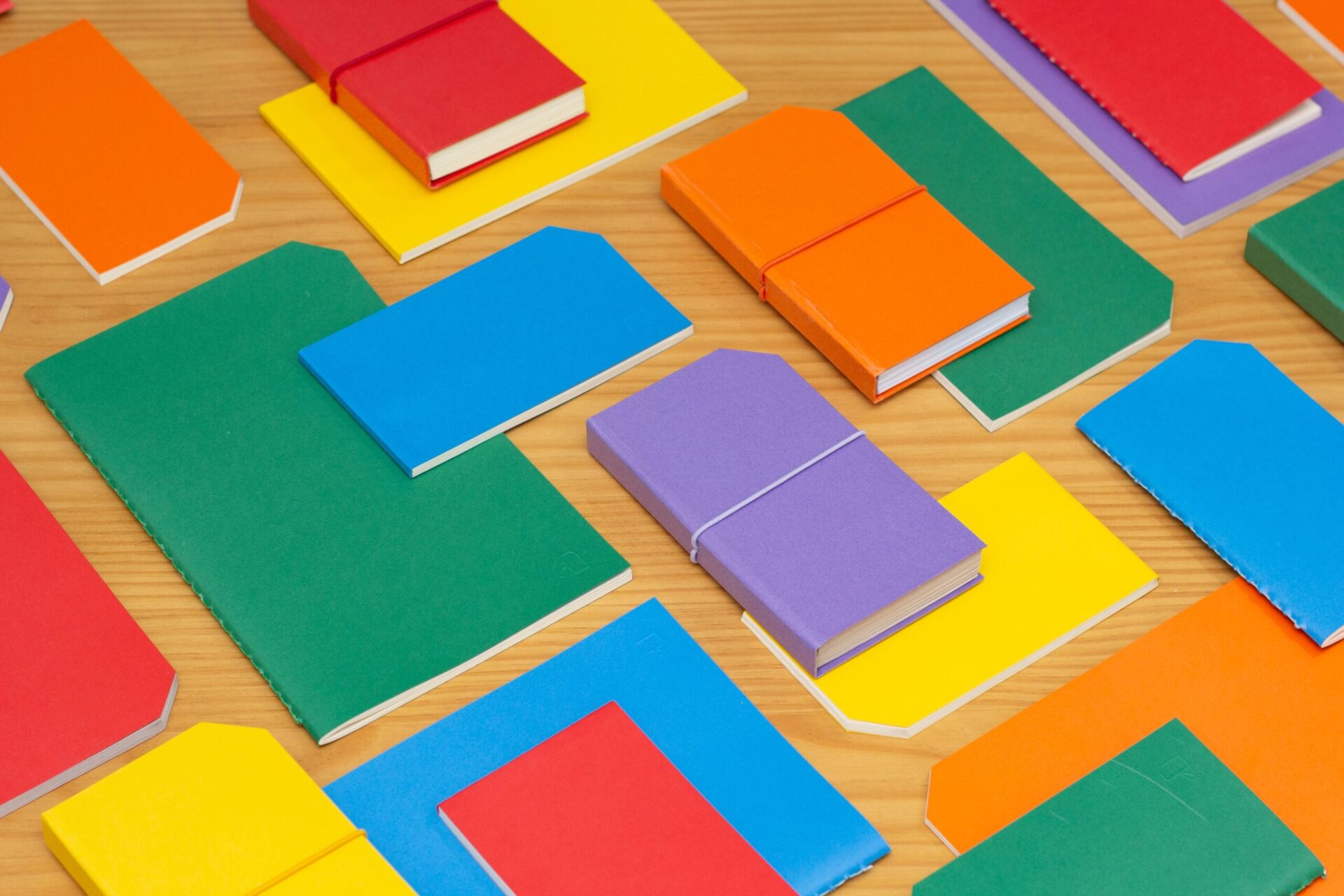 Colorful notebooks overlaid on table | OpenAsset